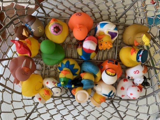 A basket full of rubber ducks and other toys.