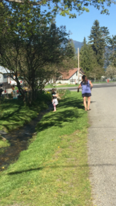 A woman and child walking down the street